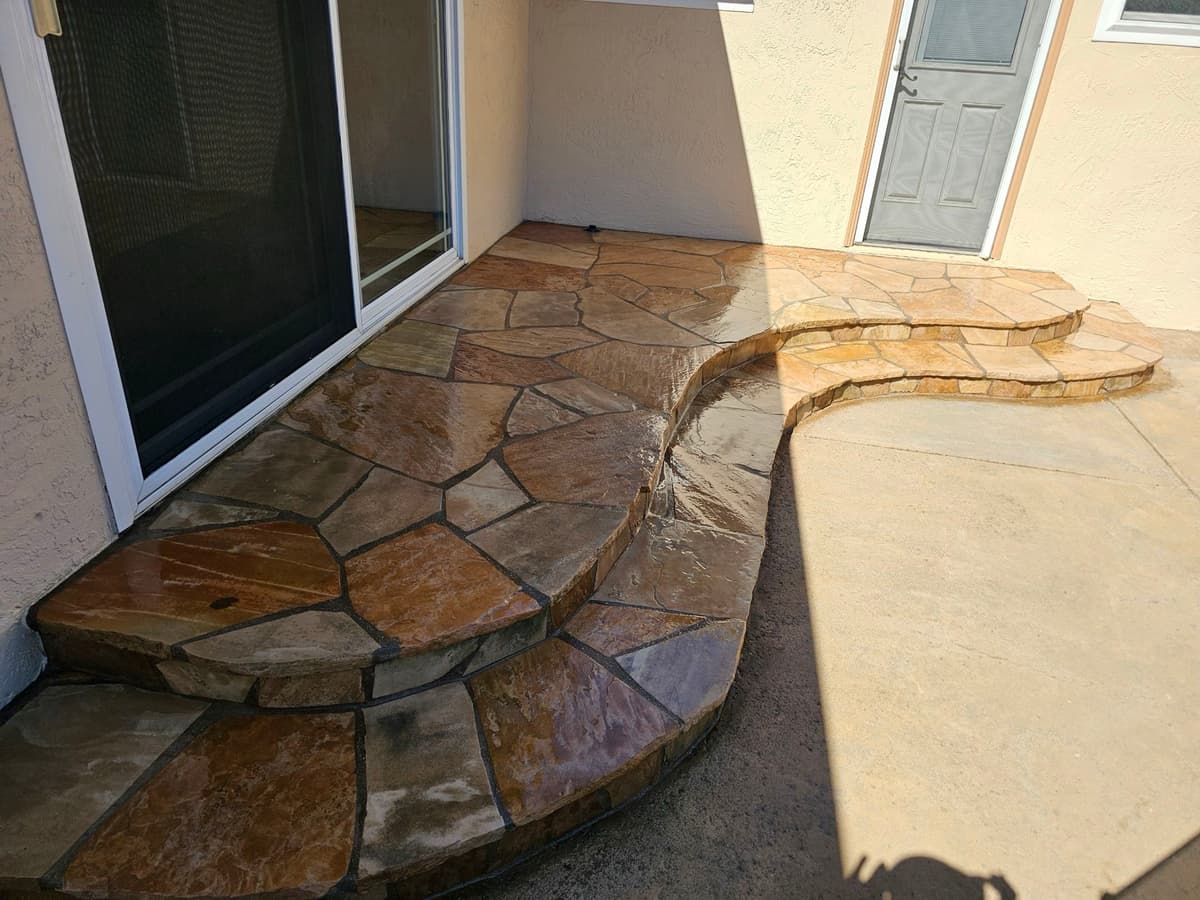 natural flagstone patio with curved steps leading to a home's back door in Stockton, California
