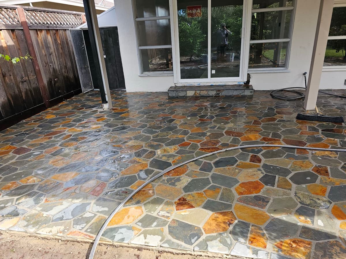 multicolor natural flagstone patio being cleaned and sealed behind a home in Stockton, California