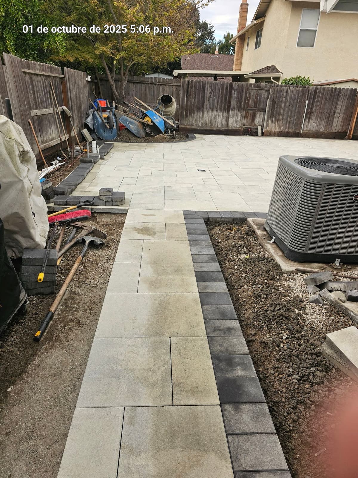 large-format light gray paver backyard patio nearing completion in Stockton, California