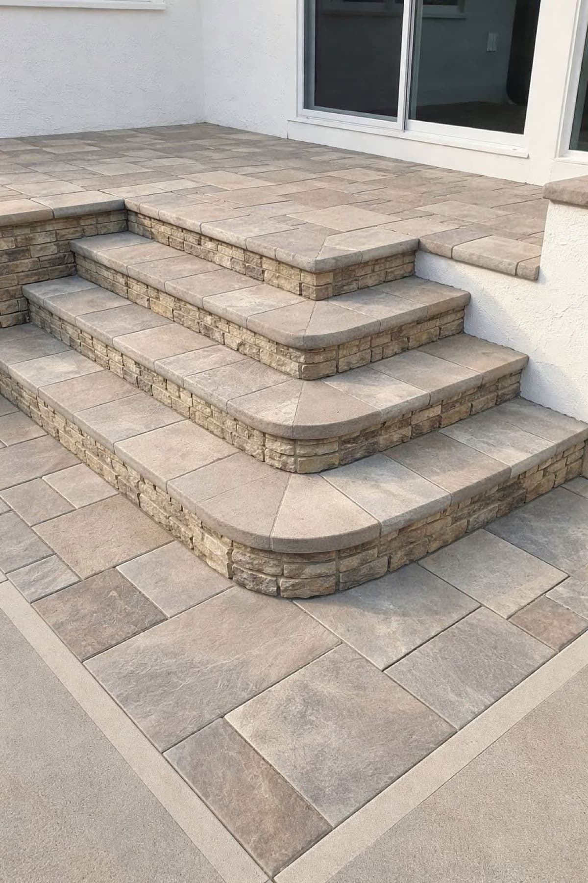 paver patio with curved bullnose steps and stacked stone risers in Stockton, California