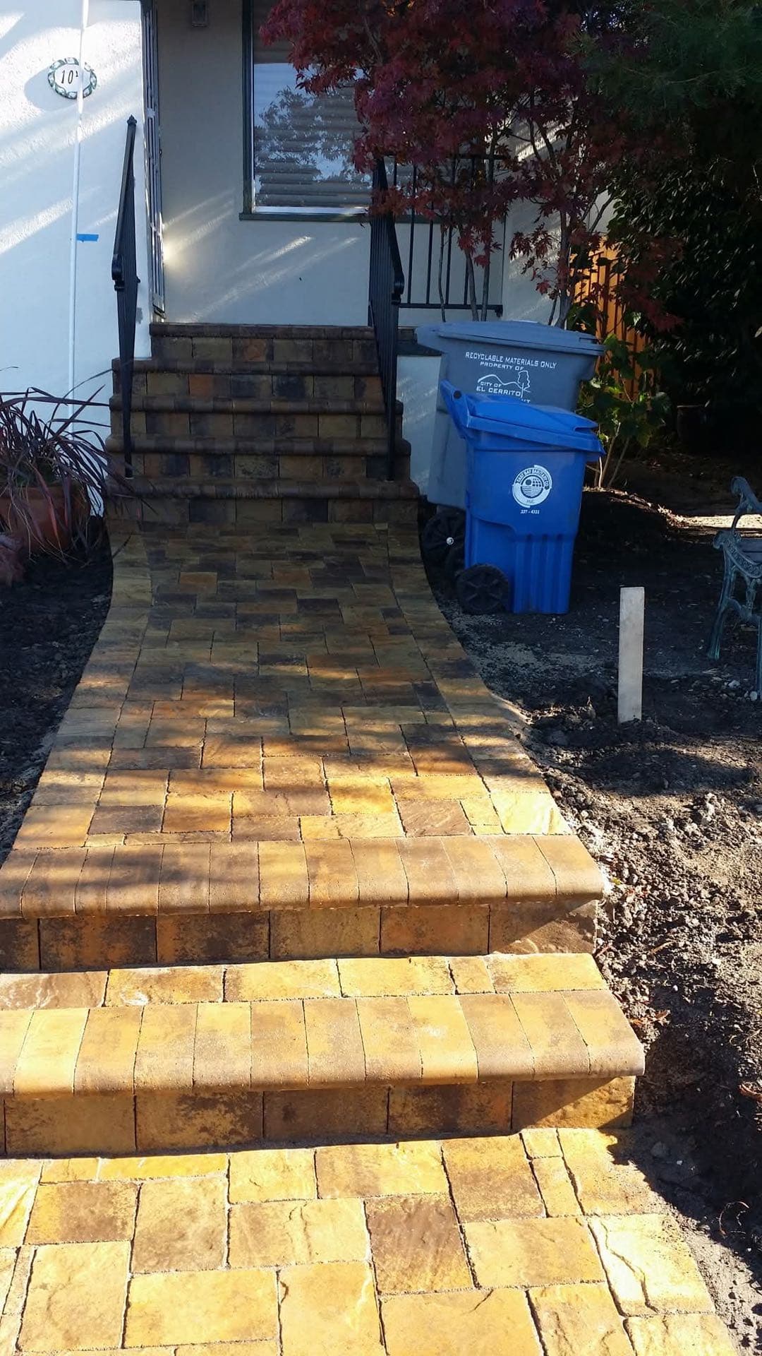 paver walkway and front entry steps leading up to a home's front door in Stockton, California